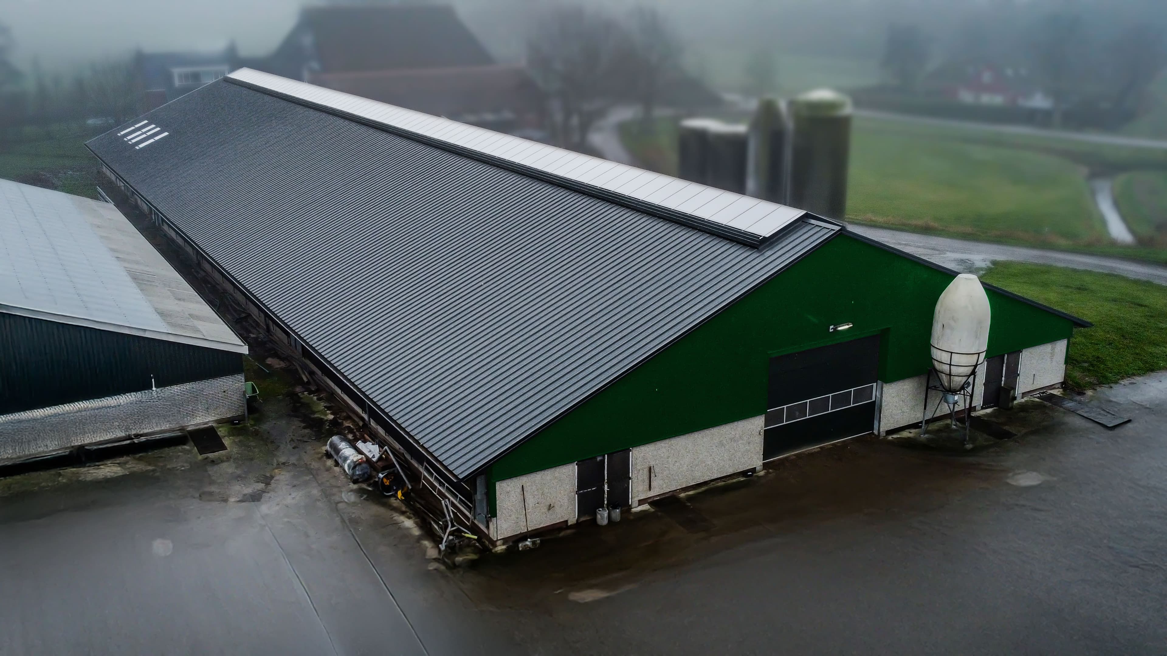 Luchtfoto van de gerenoveerde melkveestal in Dokkum met geïsoleerde dakpanelen
