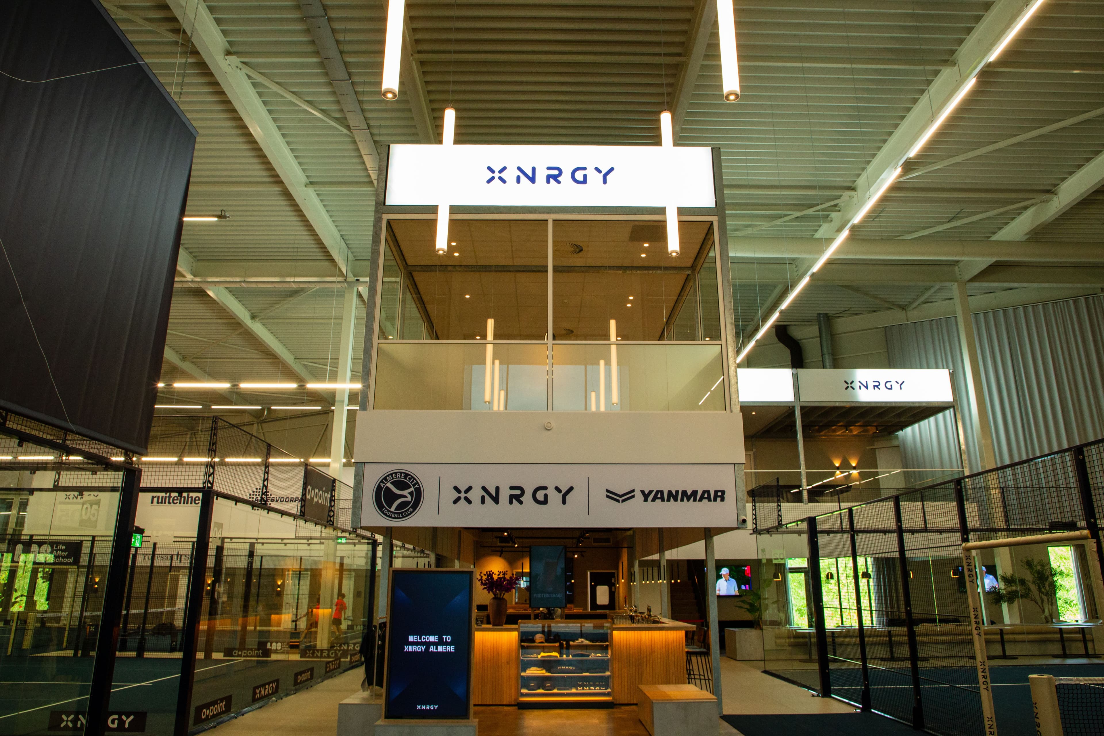 Entree en centrale ontmoetingsruimte van de XNRGY padelhal in Almere.